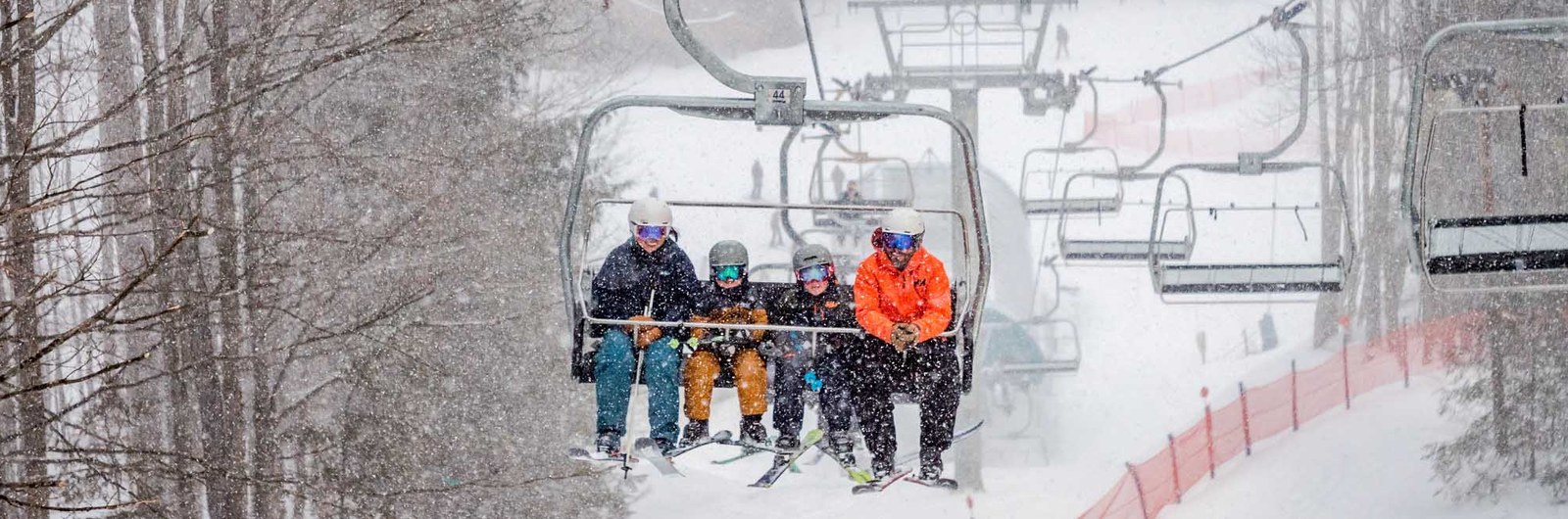 Two parents and two children ride up the Yodeler lift.