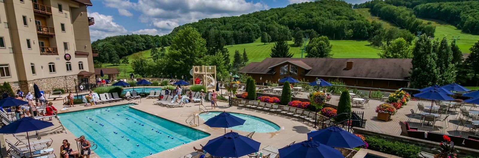 Overhead view of the pool complex at Holiday Valley with a view of the hills in the background