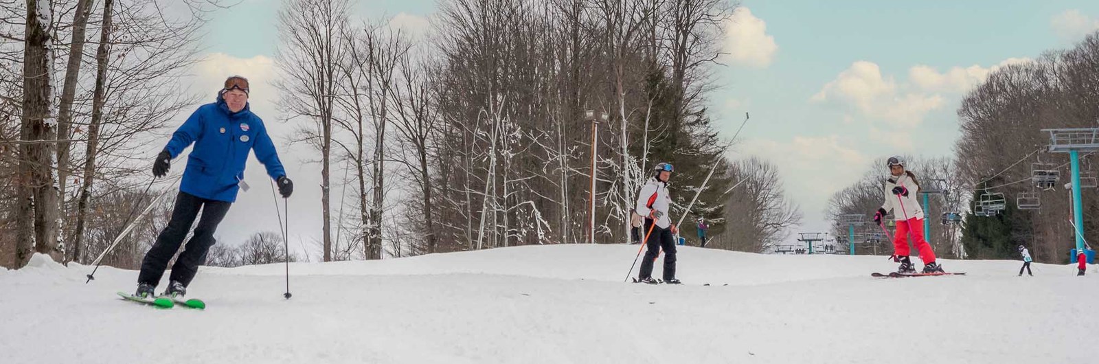 A Snowsports Instructor leads a group down Mardi Gras.