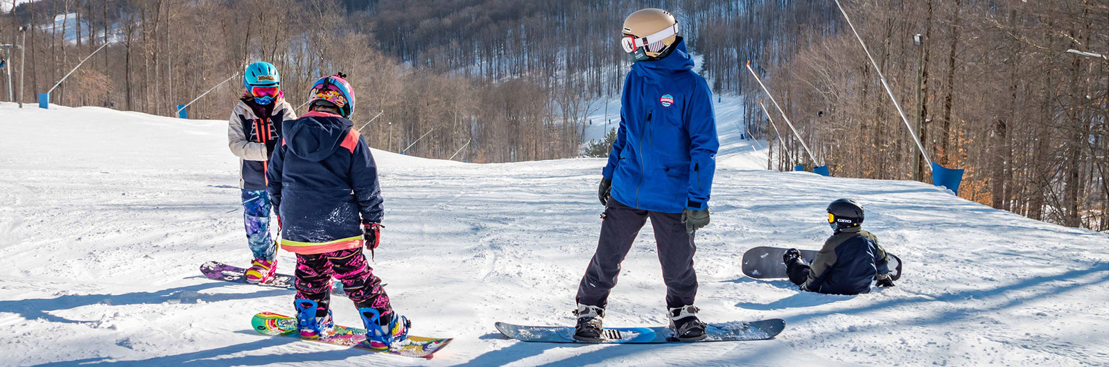 kids in a snowboard lesson