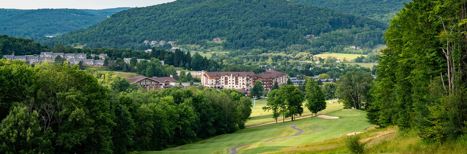View of gold course fairway with view of Holiday Valley lodge in the distance