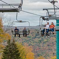 People riding the Mardi Gras lift during Fall Festival.