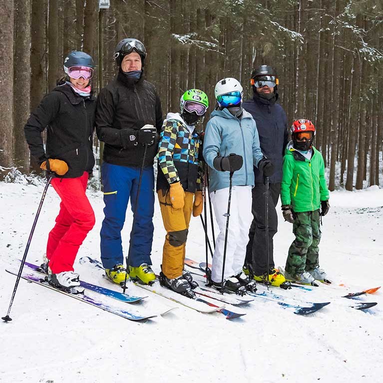 A family of skiers posing for a picture.