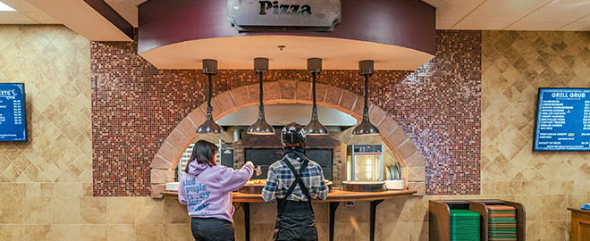Two people ordering pizza at the Mountainside Grill