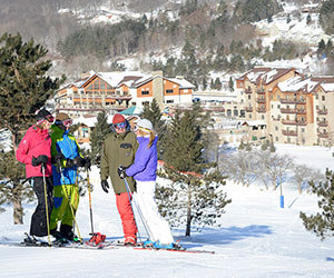 skiers and snowboarder overlooking Tamarack