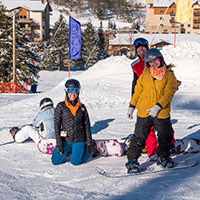 Class of women learning to snowboard