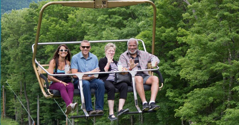 people riding chairlift in summer